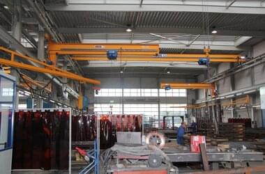 Overhead travelling crane,  jib crane and wall travelling crane at work of serial welding shop in the company STAJA