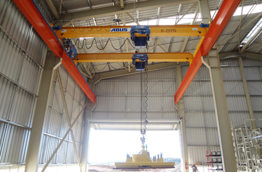 Chain hoist in use for transporting grain harvesters