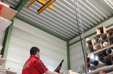 Suspended rail system with electric chain hoist ABUCompact GM2 in German carpenter's workshop