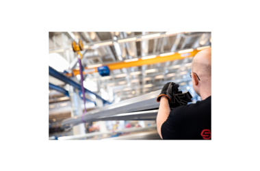 Close-up of employee on wire rope hoist of a single girder travelling crane