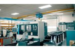 A factory floor with machine tools. An ELV bridge crane with electric wire rope hoist travels along a crane runway.