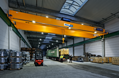 Double-girder crane with LED light line loads truck at Spedition Menn in Kreuztal, Germany 